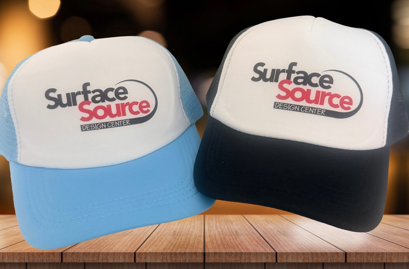Blue and black custom trucker hats for Surface Source Design Center