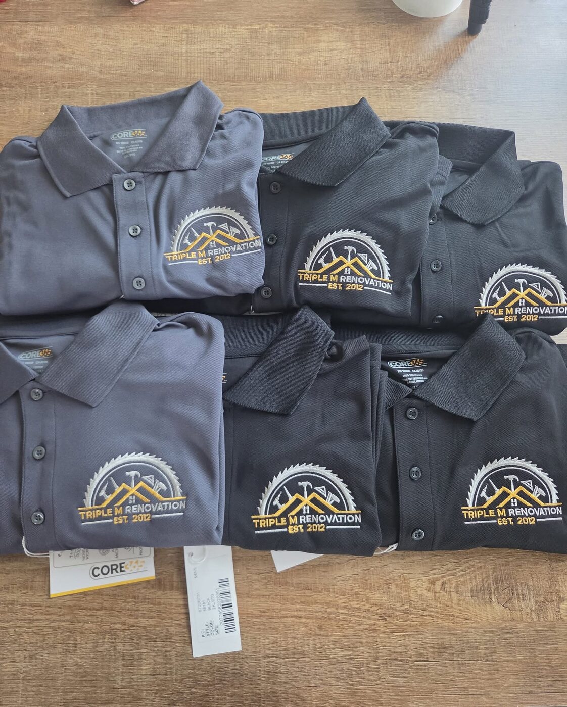 Gray and black embroidered polo shirts for Triple M Renovation