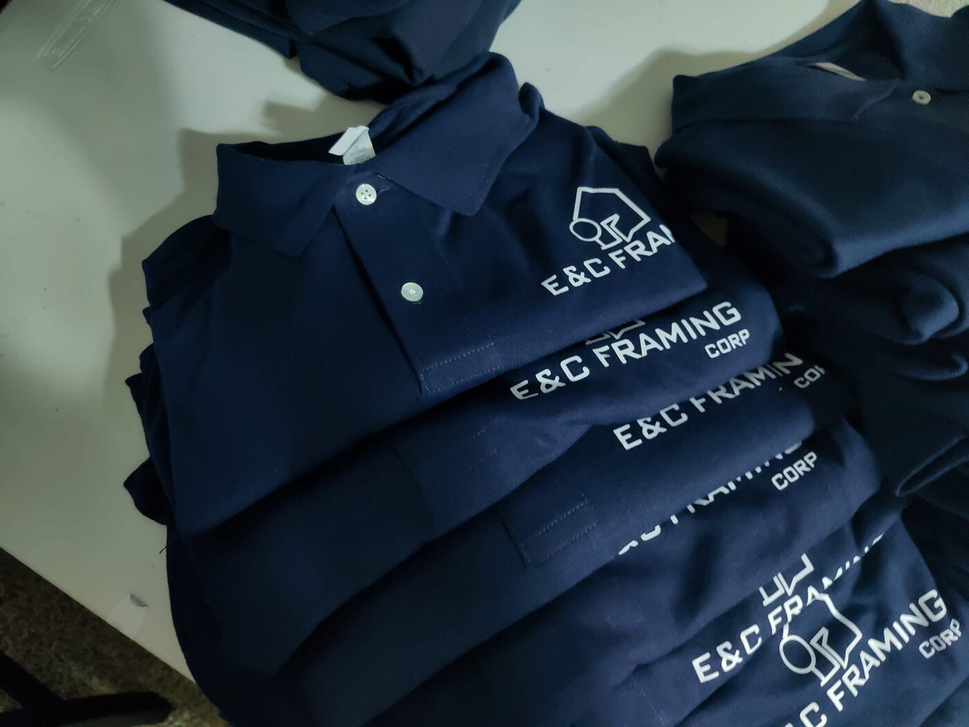 Navy embroidered polo shirts for E&C Framing Corp